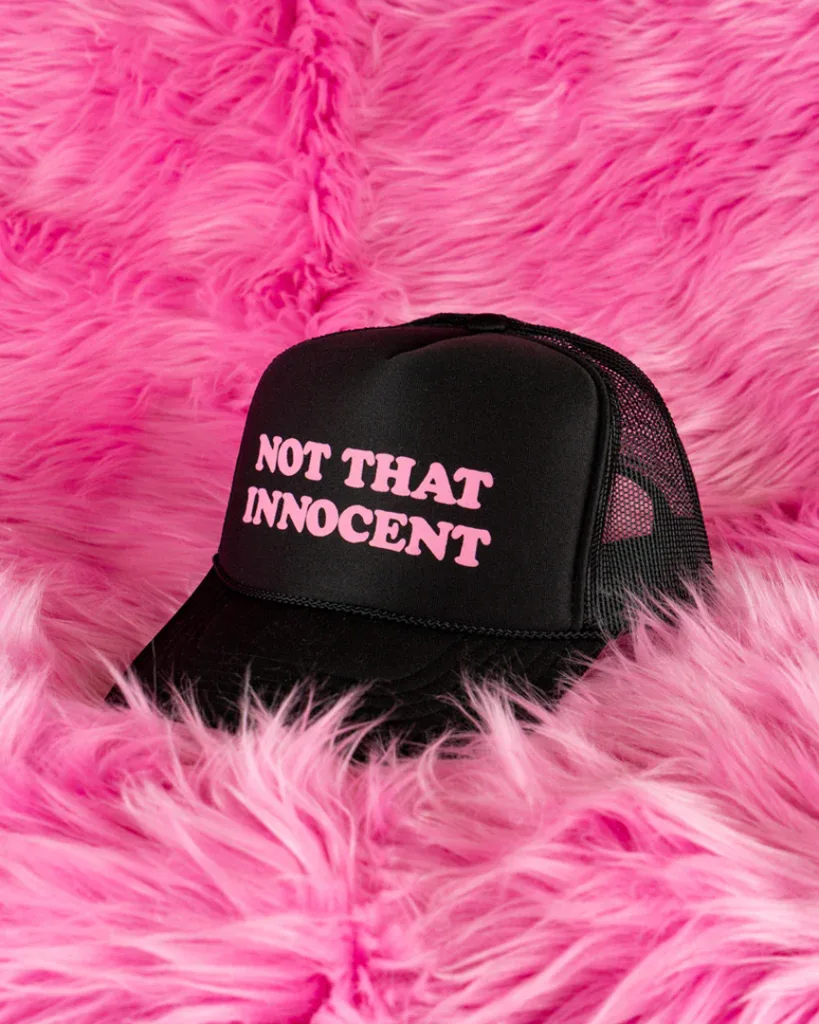 A black and pink "not that innocent" trucker hat.