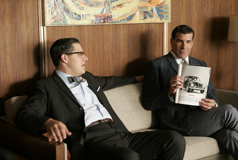 The Sterling Cooper men discussing the VW ad