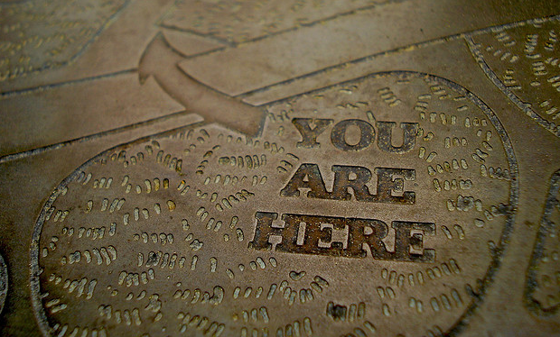 You Are Here sign in sidewalk