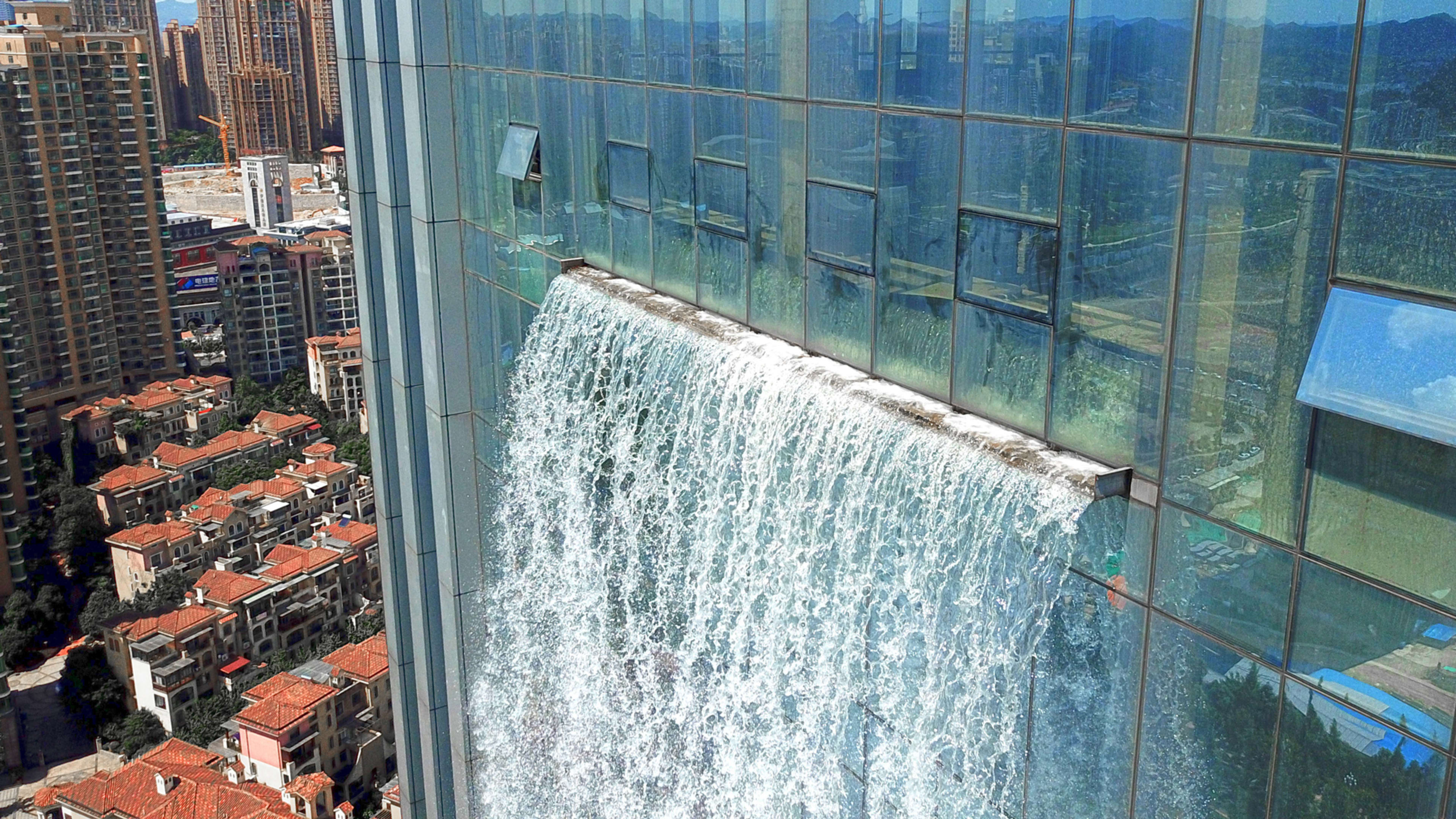 This wild new skyscraper is topped with a functioning waterfall