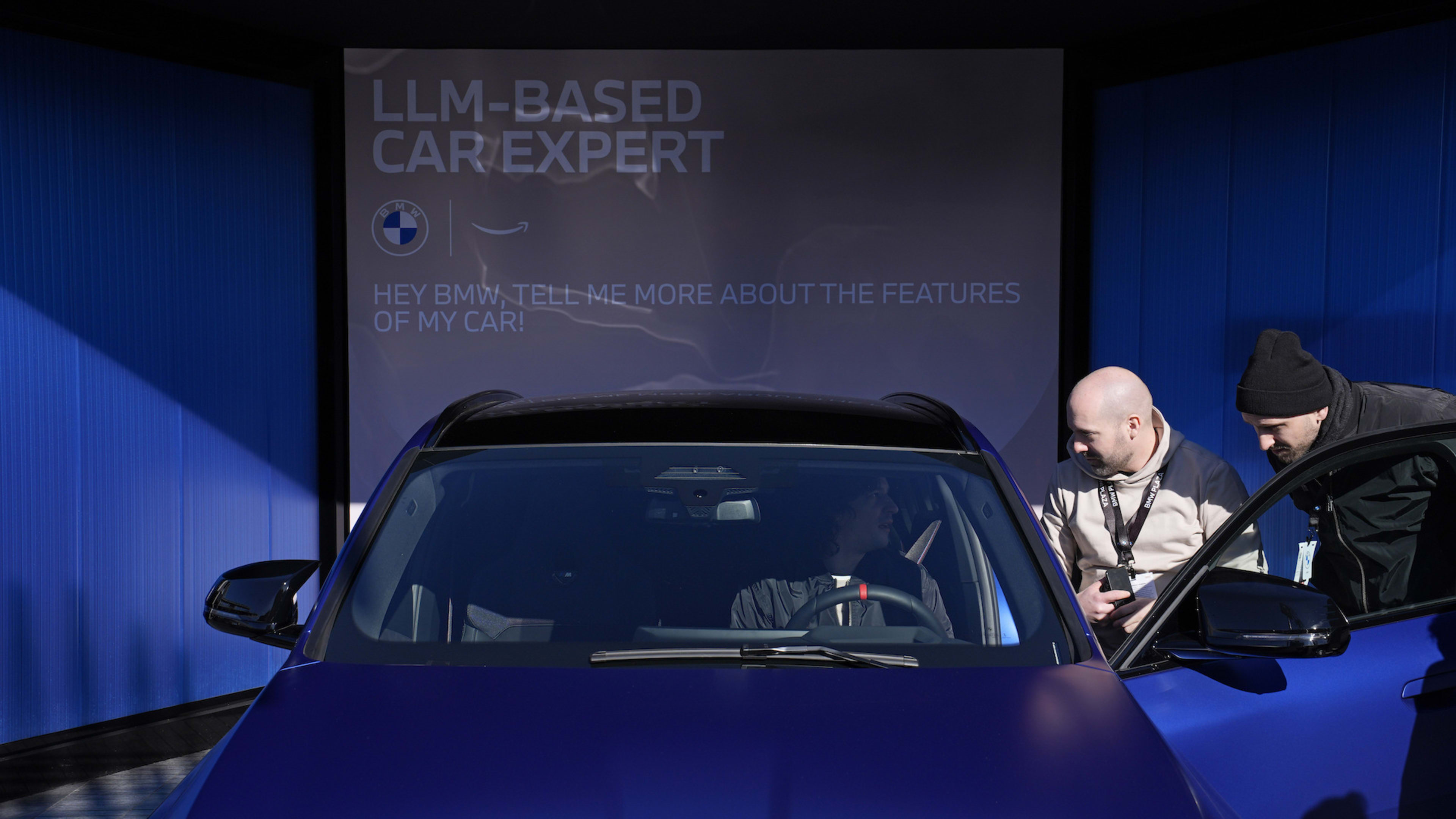 People look in a car used to demonstrate BMW's in-car personal assistant