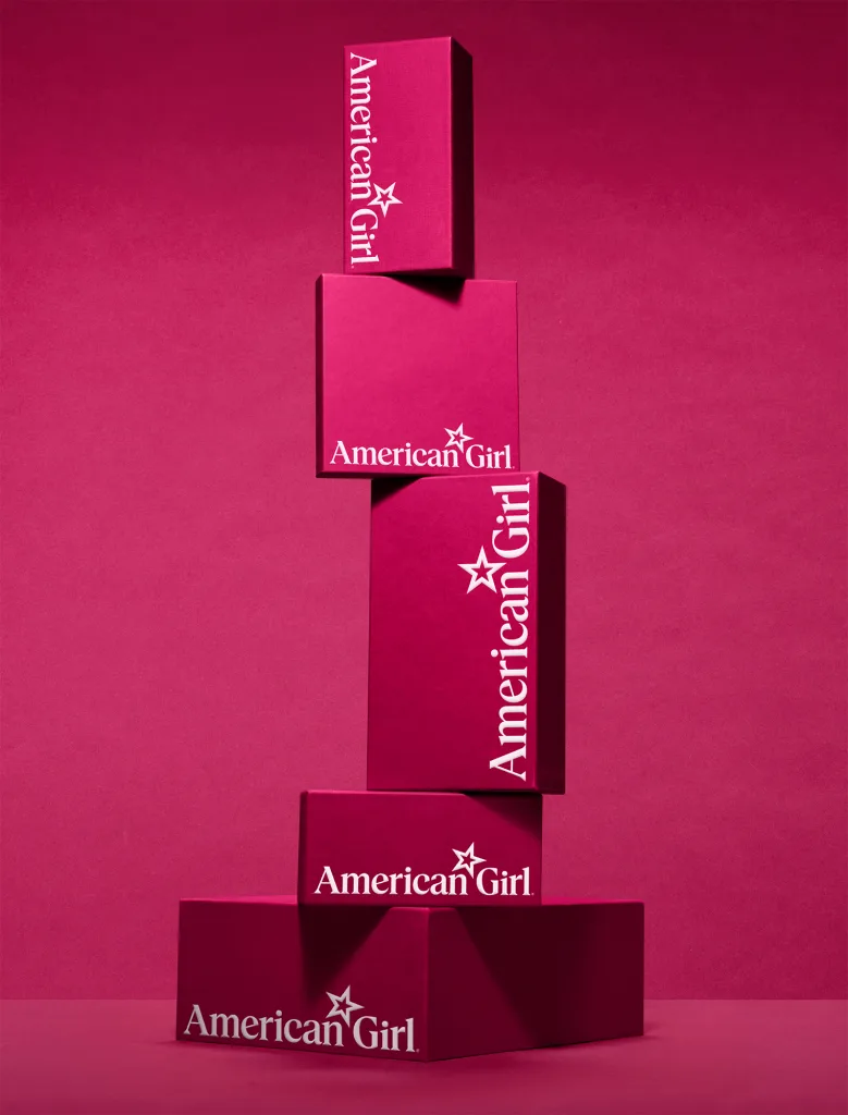 A stack of branded American Girl boxes.