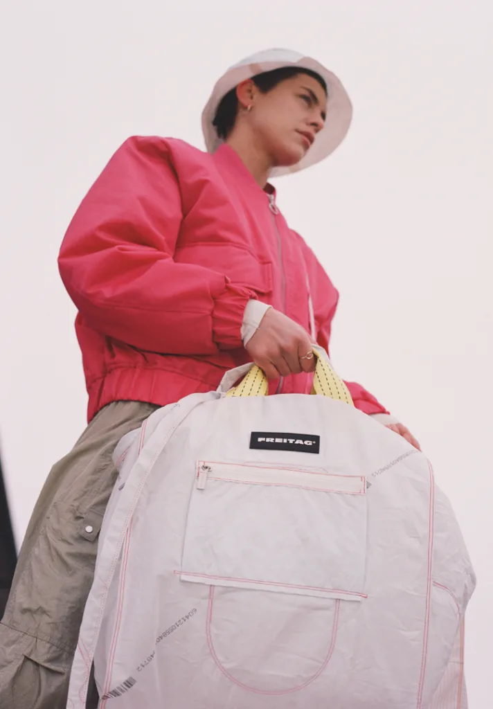 A photo of a model carrying a Freitag bag from below.