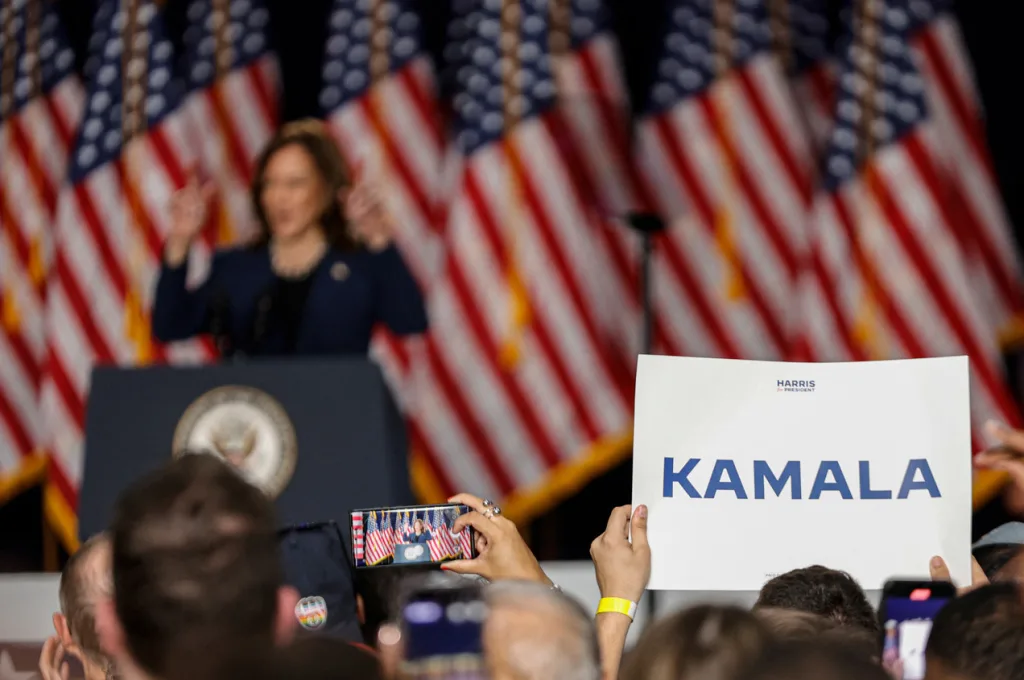 Harris campaign branding on a placard that reads "Kamala."