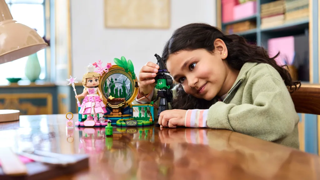 A girl playing with a lego evil set.