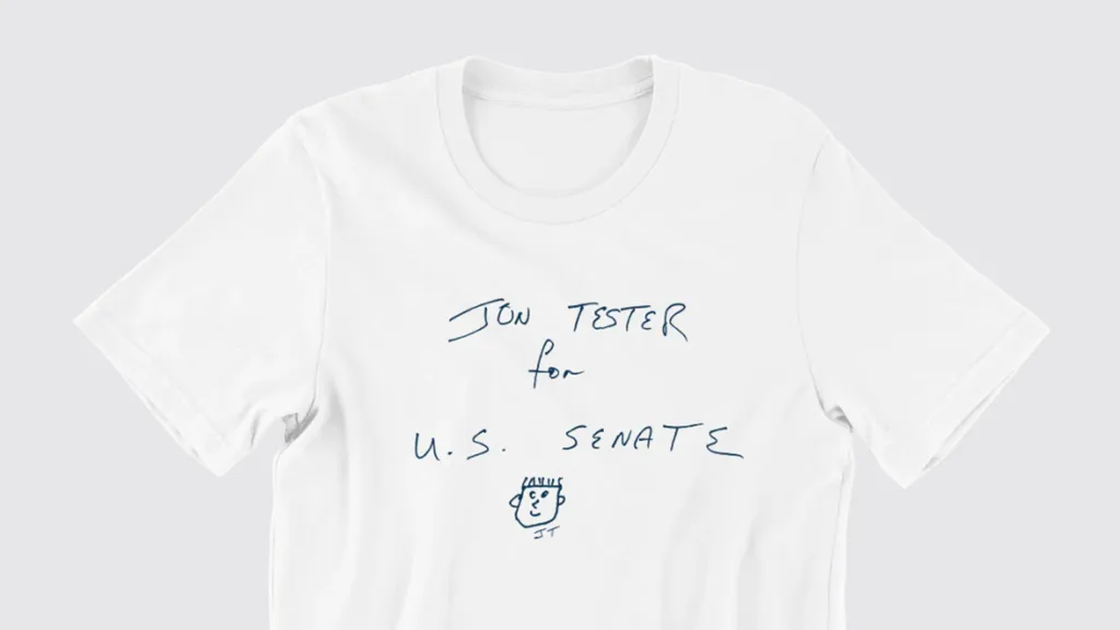 One item in John Tester's merch shop: a white t-shirt that reads "Jon Tester for U.S. Senate" in all-caps handwriting.