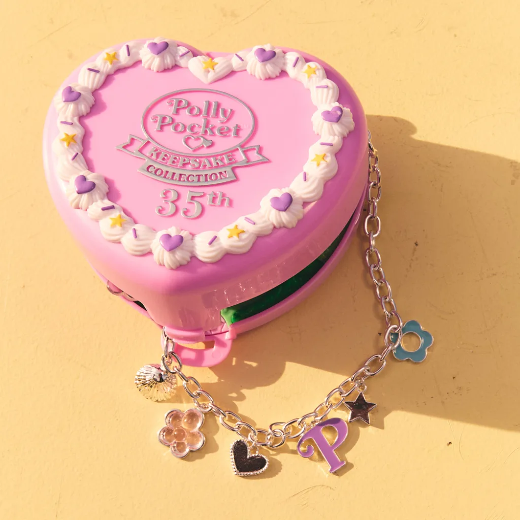 A photo of the Polly Pocket 35th anniversary keepsake collection box, in the shape of a pink plastic heart.