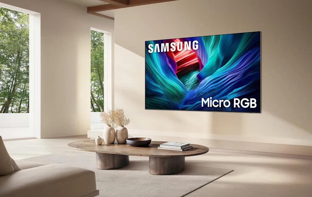 An image of the Samsung Micro RGB TV mounted on a beige living room wall.
