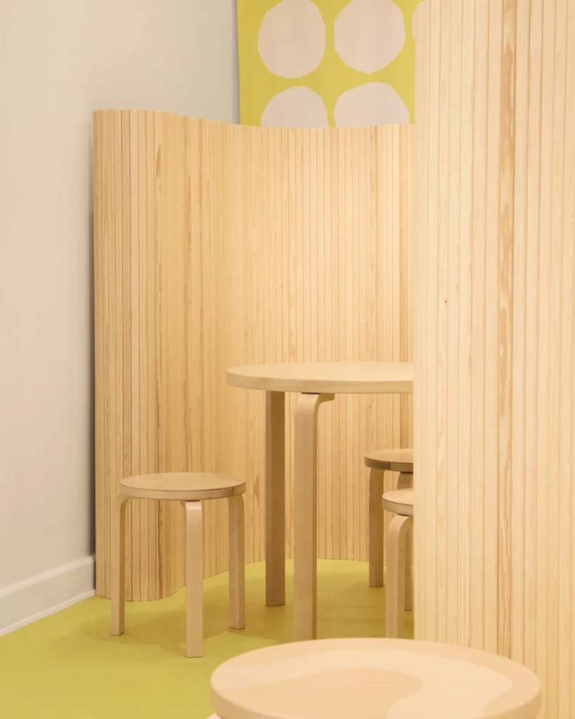 A product photo of a table and stools from the Artek Marimekko collection in situ.