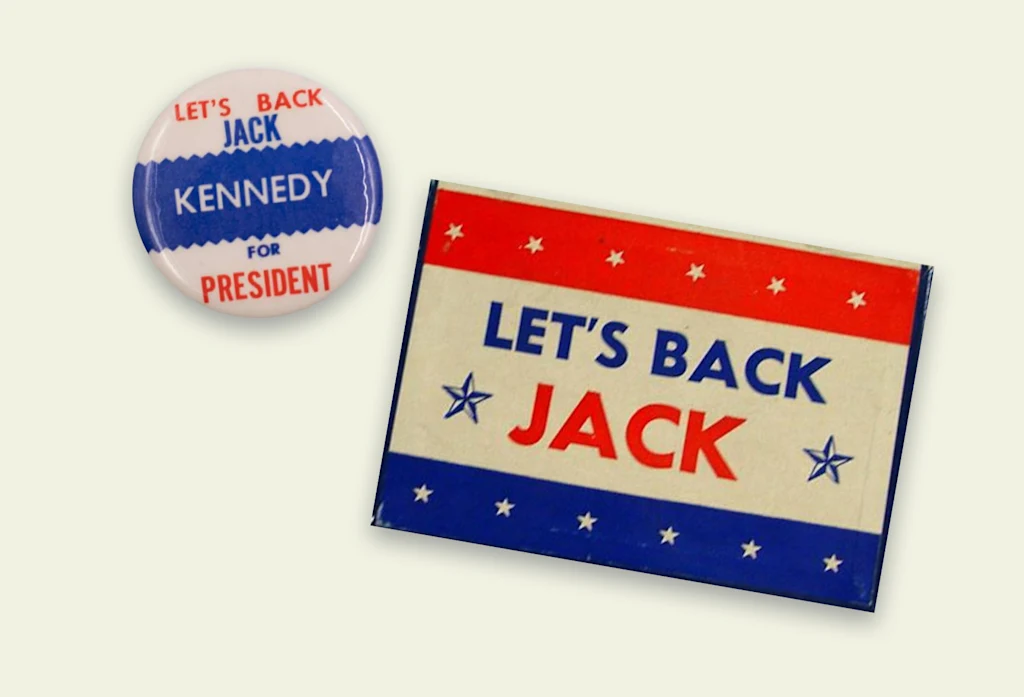 Red, white, and blue pins that read "Let's Back Jack" from former President John F. Kennedy's 1960 campaign.