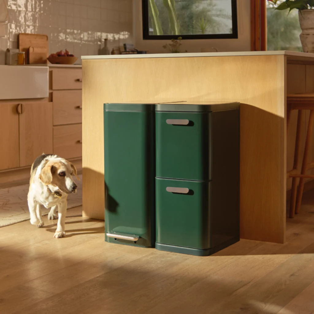 An in situ photo of a green Caraway trash can and recycling system.