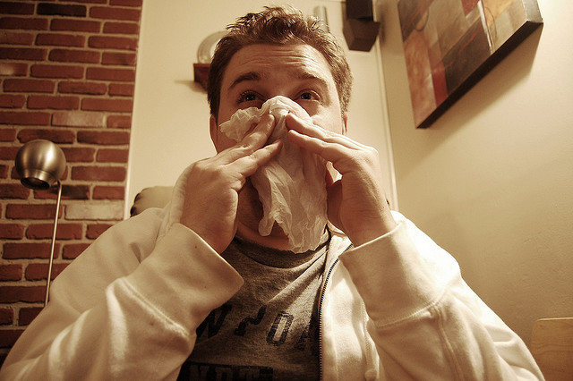 man blowing nose